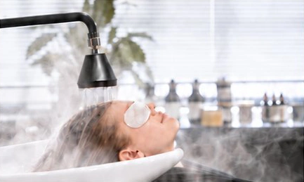 Relaxed client receiving waterfall head spa treatment